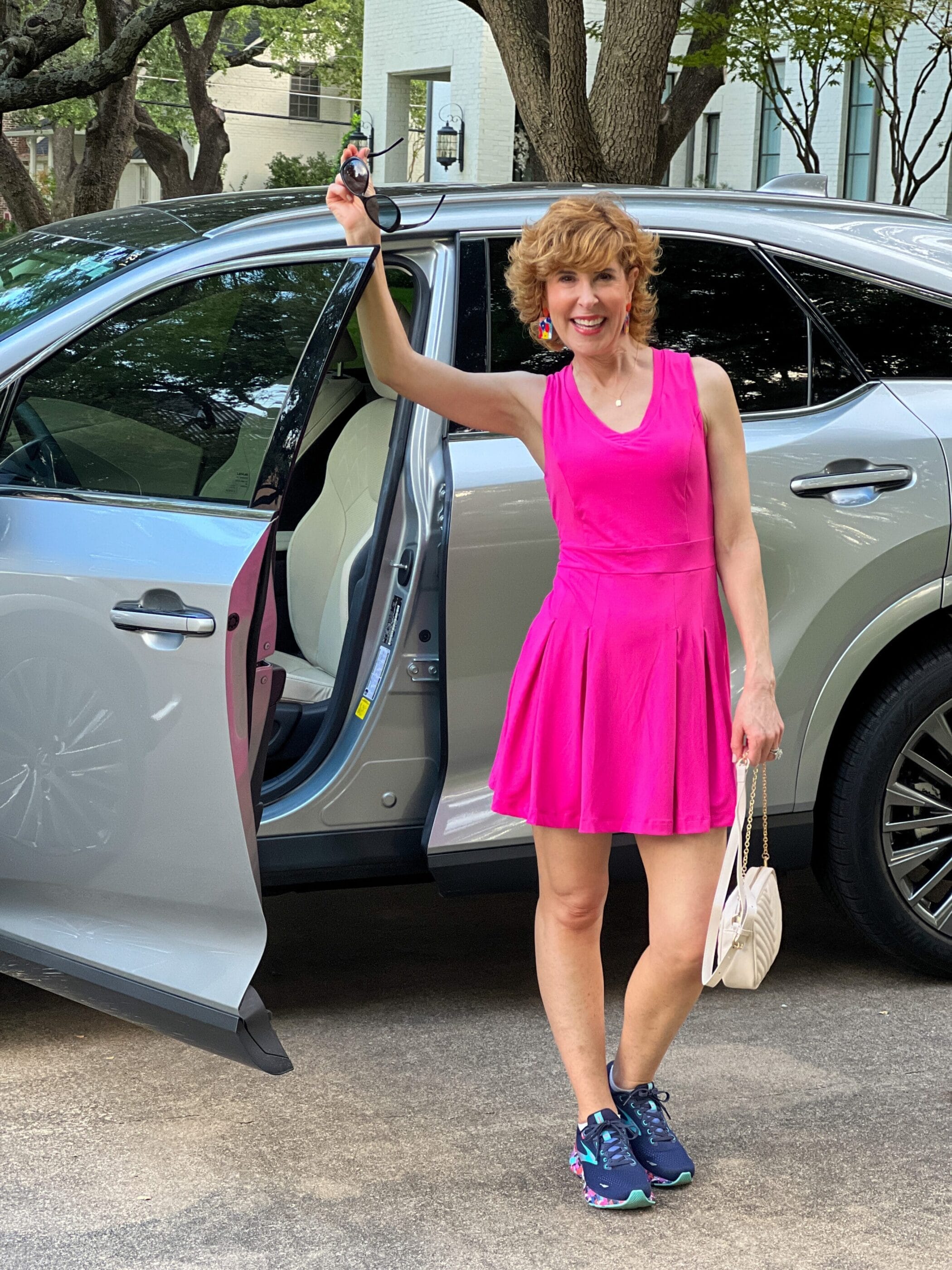 woman over 50 standing by her car wearing Better Than Every Hot Pink Tennis Dress w/ Shorts
