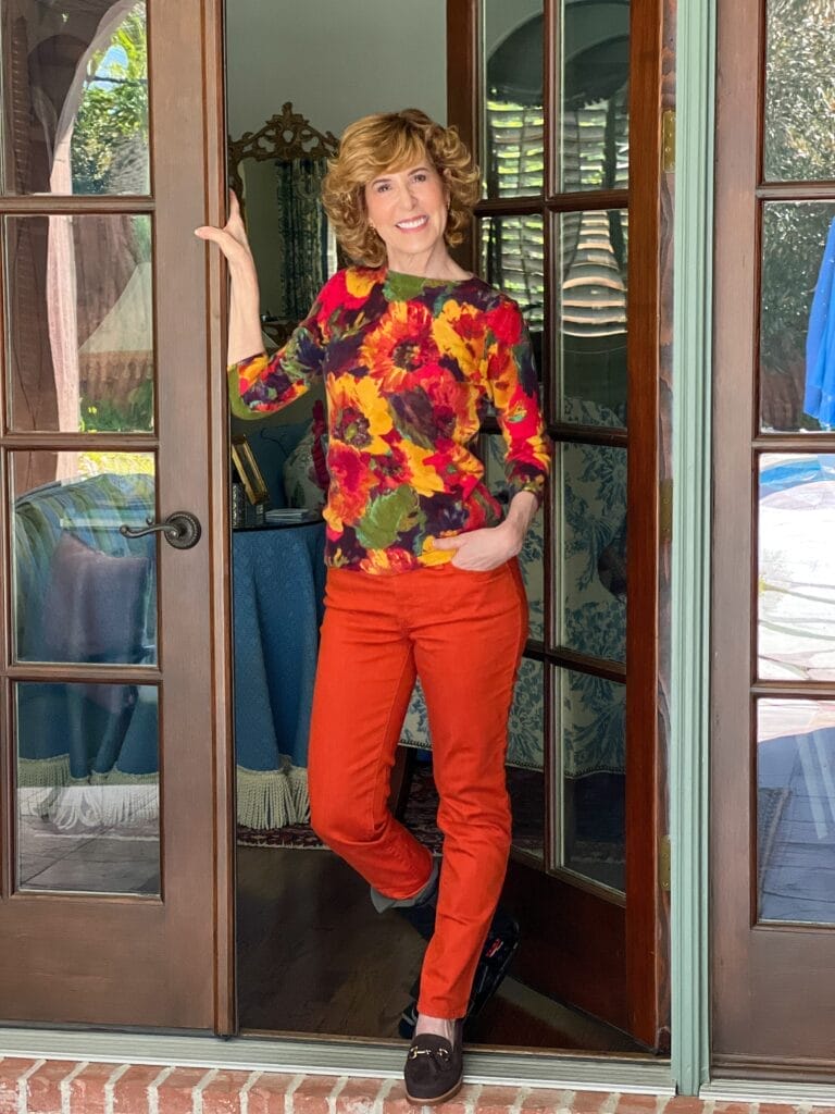 woman over 50 standing by door in fall outfit