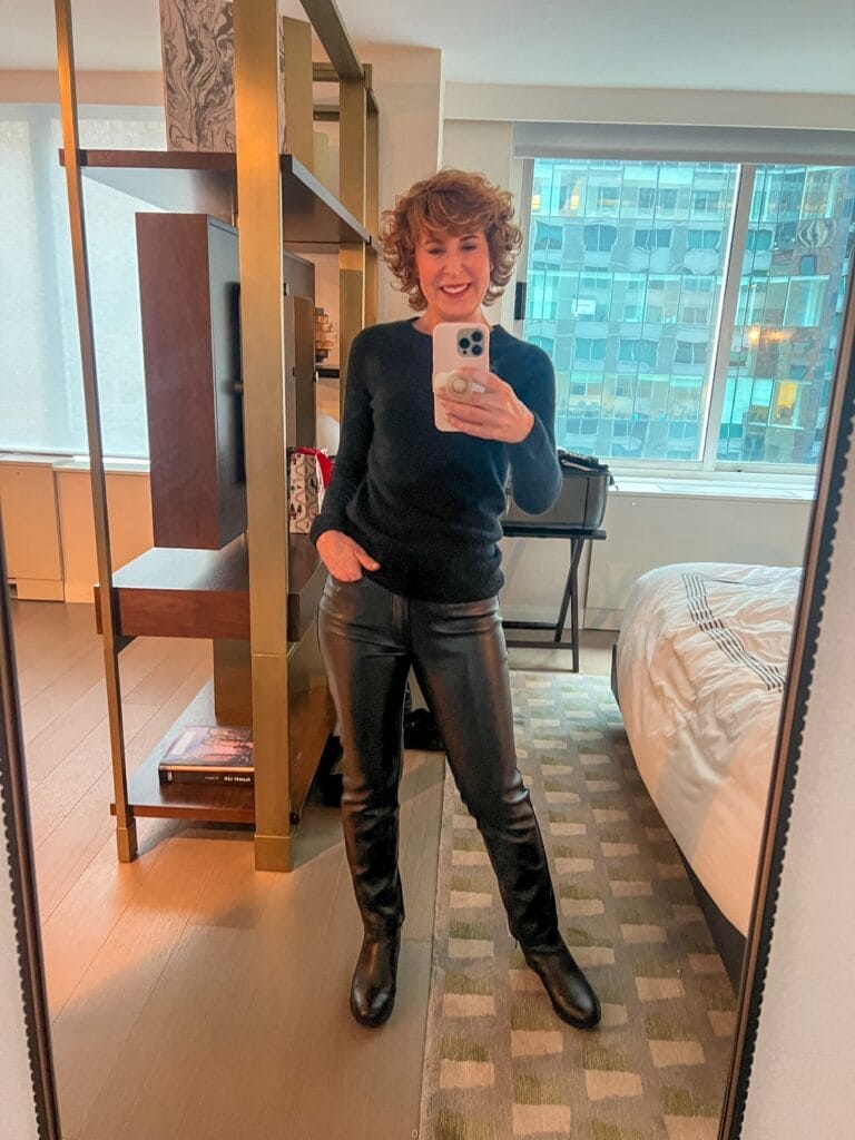 selfie of woman standing in hotel room dressed in all black