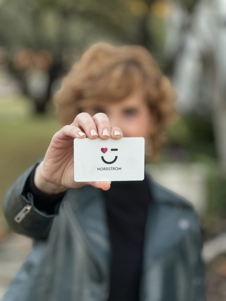 woman holding a gift card