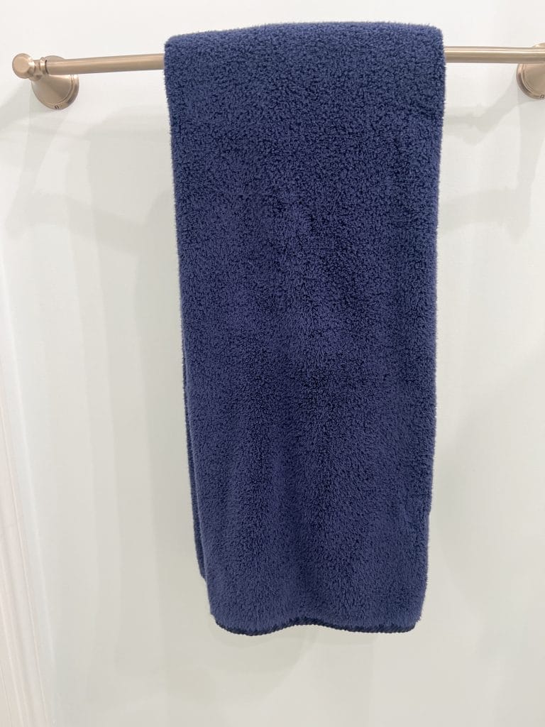 navy blue towels in bathroom in waco loft after remodel