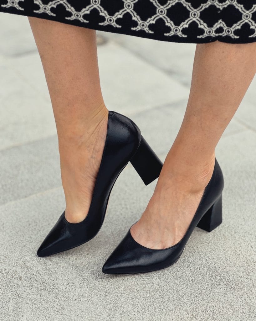 woman's legs and feet wearing marc fisher block heel pumps