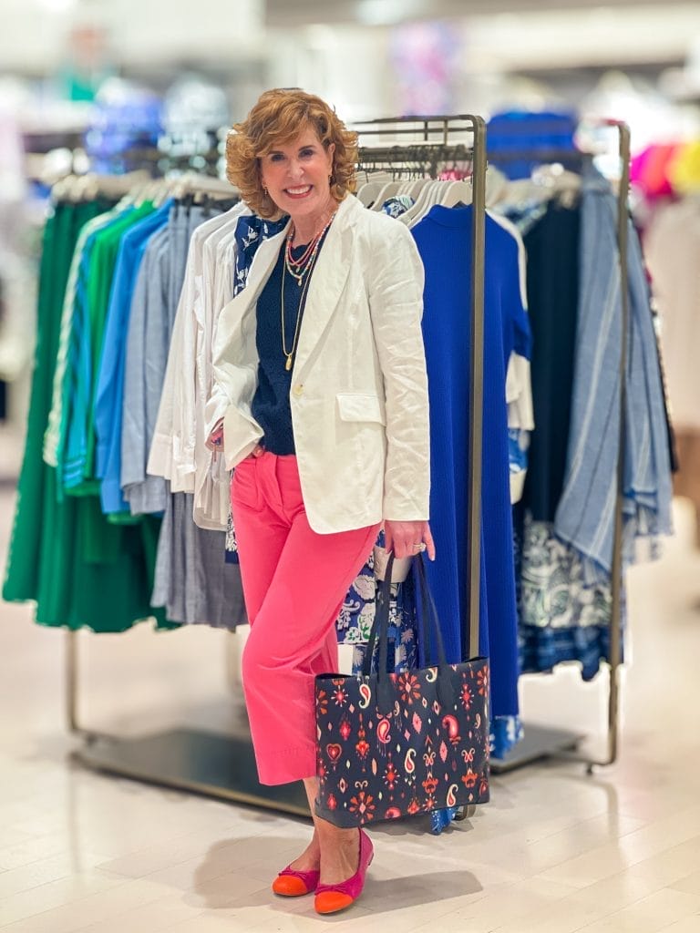 woman over 50 wearing pink crop pants and blue top and white blazer in talbots store