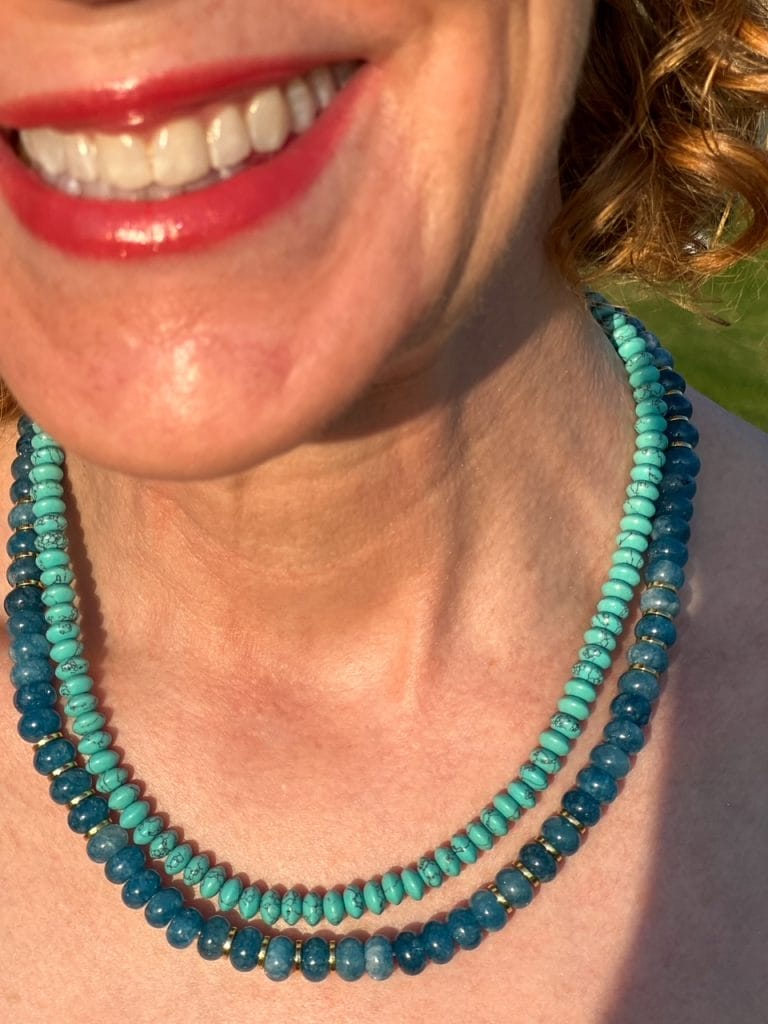 picture of a woman's neck wearing a turquoise necklace