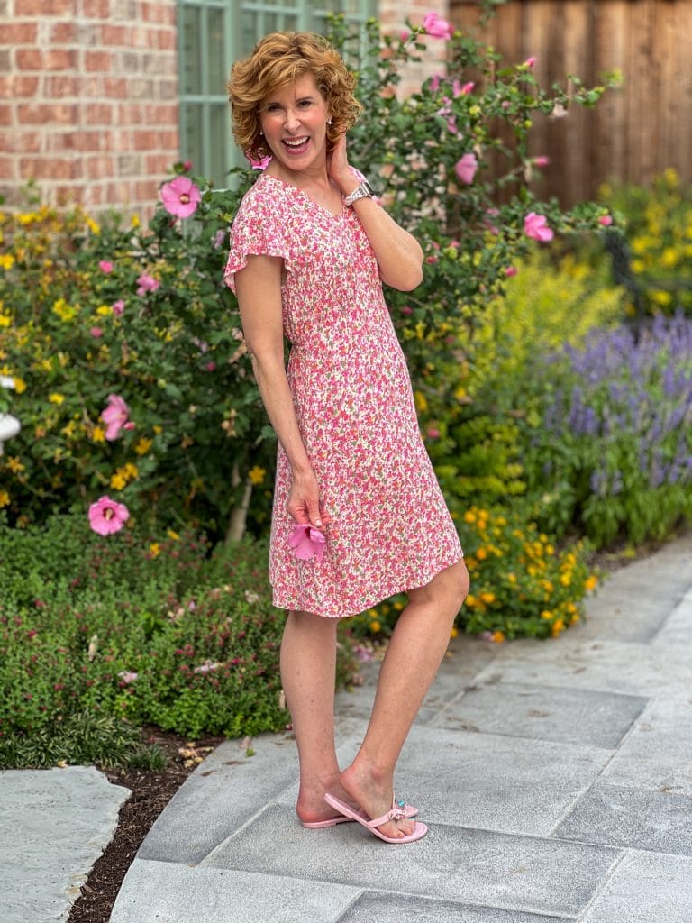 woman standing in backyard wearing a walmart floral dress thinking about what she loves about america