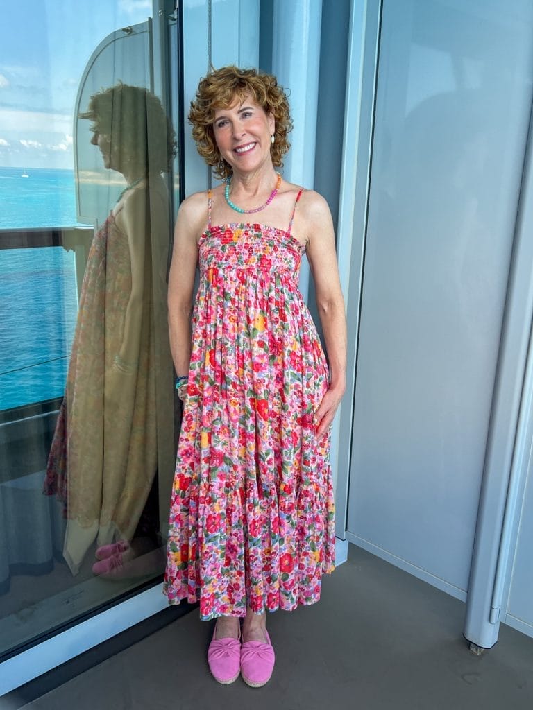 woman standing on balcony of a cruise ship wearing natural life convertible dress
