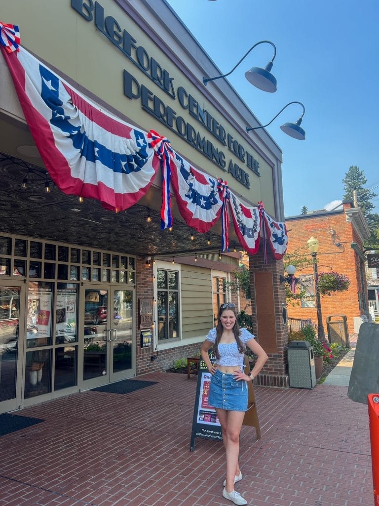 girl in front of bigfork mountain playhouse in bigfork montana