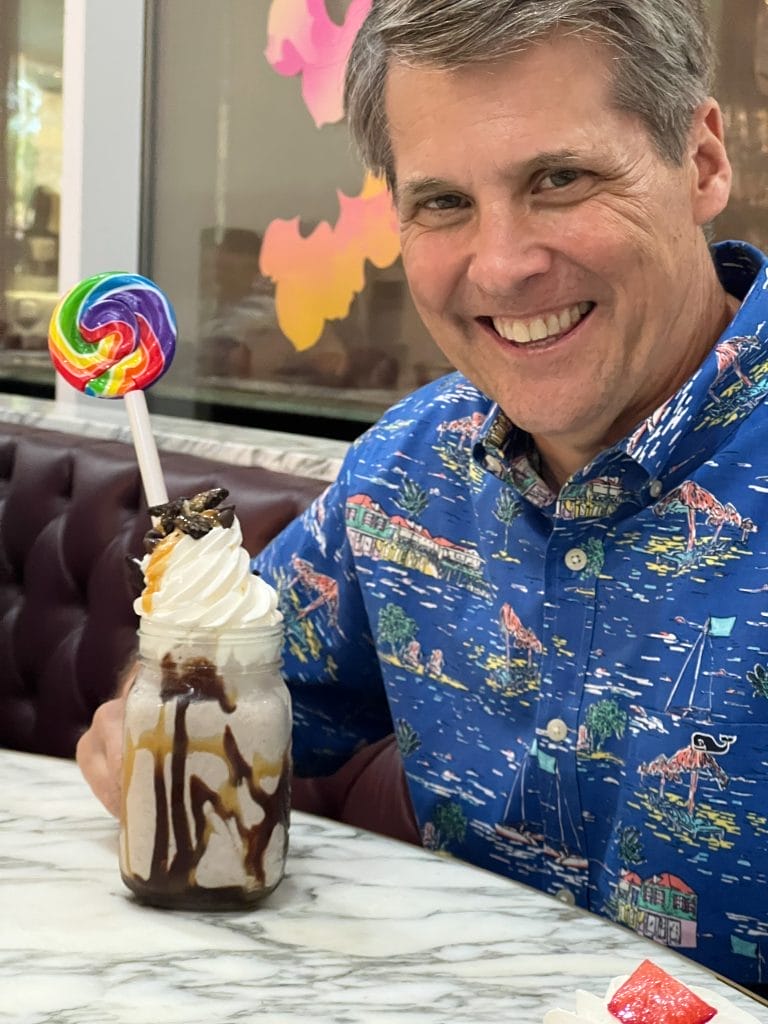 man wearing vineyard vines button down with colorful dessert