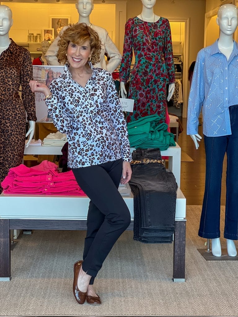 woman over 50 standing in a talbots store wearing on of the 2024 fall trends