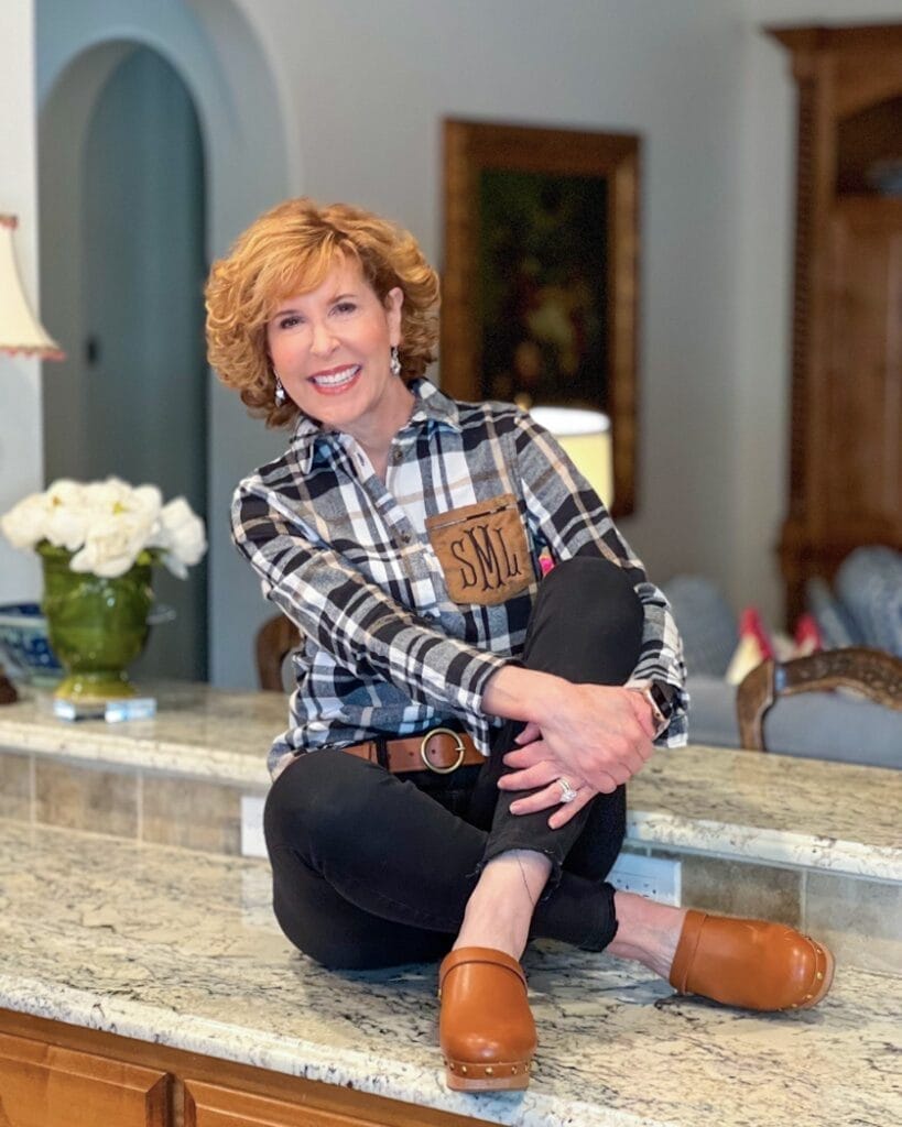 woman sitting on counter wearing monogrammed flannel plaid shirt from marleylilly