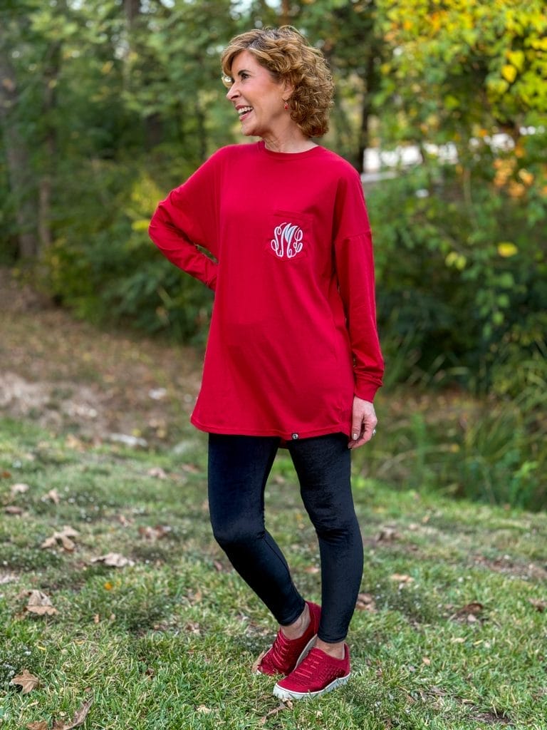 woman over 50 looking to the side wearing red long sleeve tee