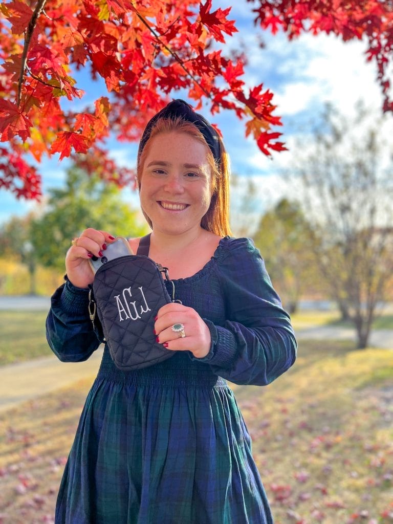 Red headed girl holiding crossbody bag from marleylilly that was a personalized gift