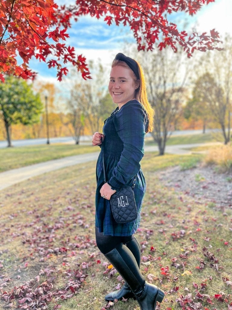 girl holding crossbody bag standing sideways looking into the cameral