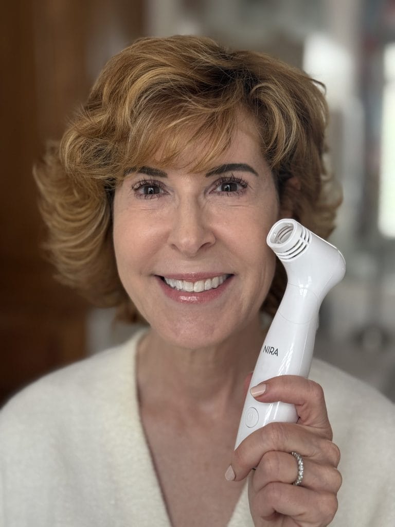 woman over 50 holding the NIRA Pro Laser