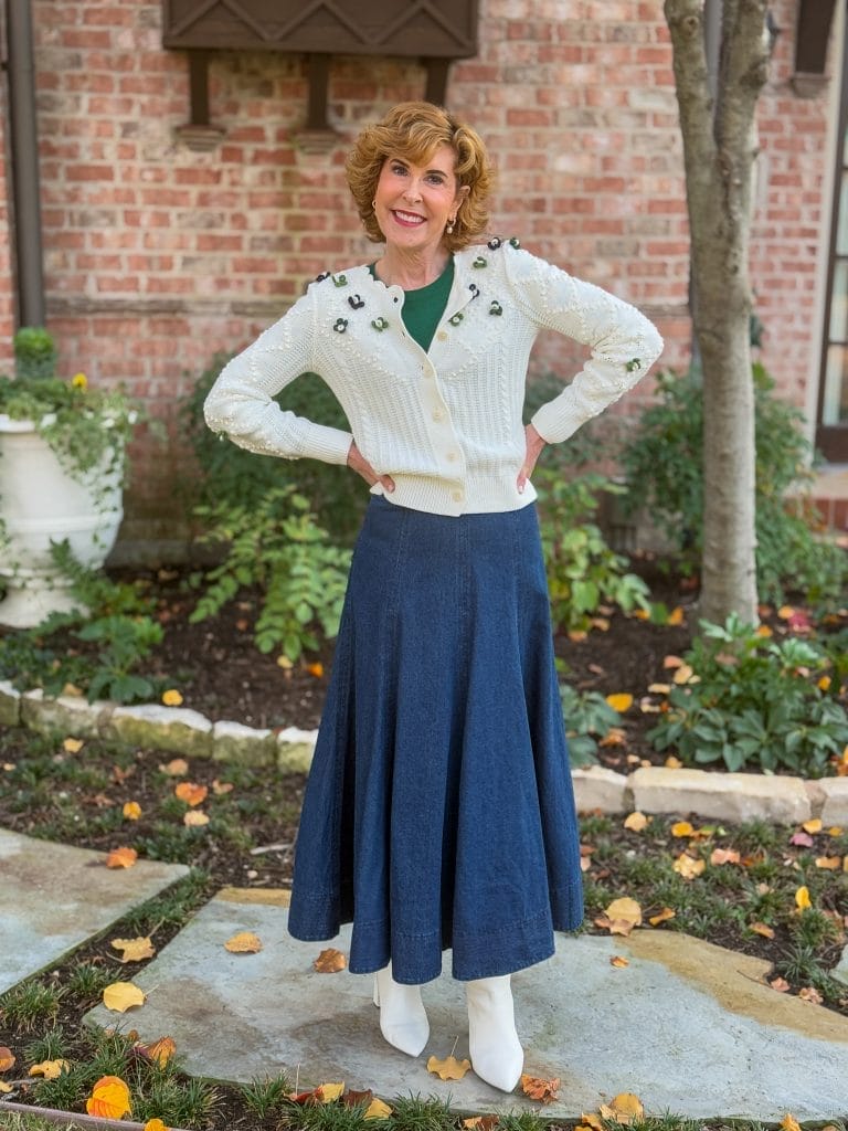 woman wearing floral cardigan and long denim skirt in front yard